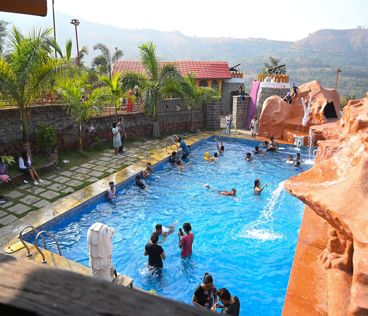 Swimming pool surrounded by a relaxing resort atmosphere